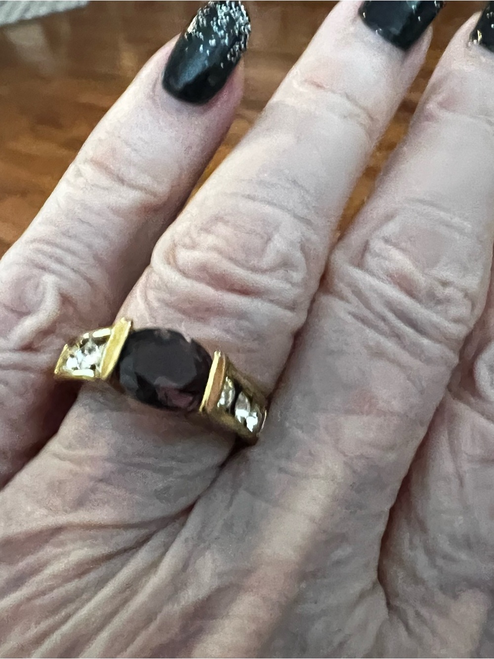 Gold Ring with Deep Garnet Center Stone and Accent Clear Stones